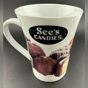 See's Candies branded white ceramic coffee mug w/images of chocolates. 12oz